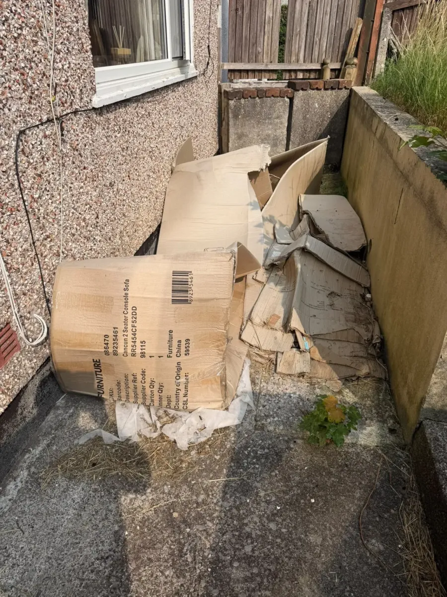 Overgrown garden in Liskeard with waste and debris before garden clearance