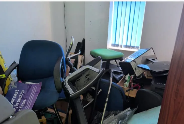 Liskeard house room cluttered with furniture and belongings before house clearance